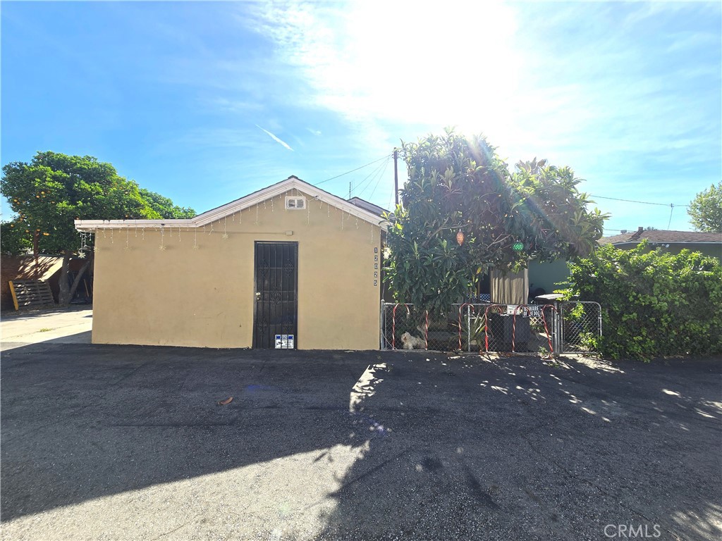 12025 Conference Street El Monte, CA 91732 - Photo 3 of 4 a view of a house with a yard and garage