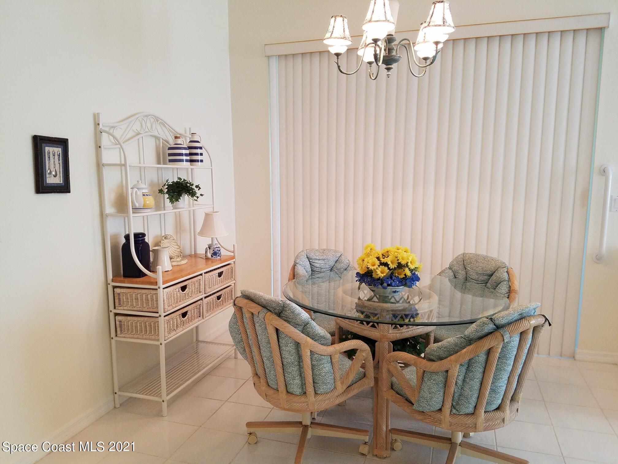 2492 Addington Circle Rockledge, FL 32955 - Photo 12 of 34 a view of a dining room with furniture and chandelier