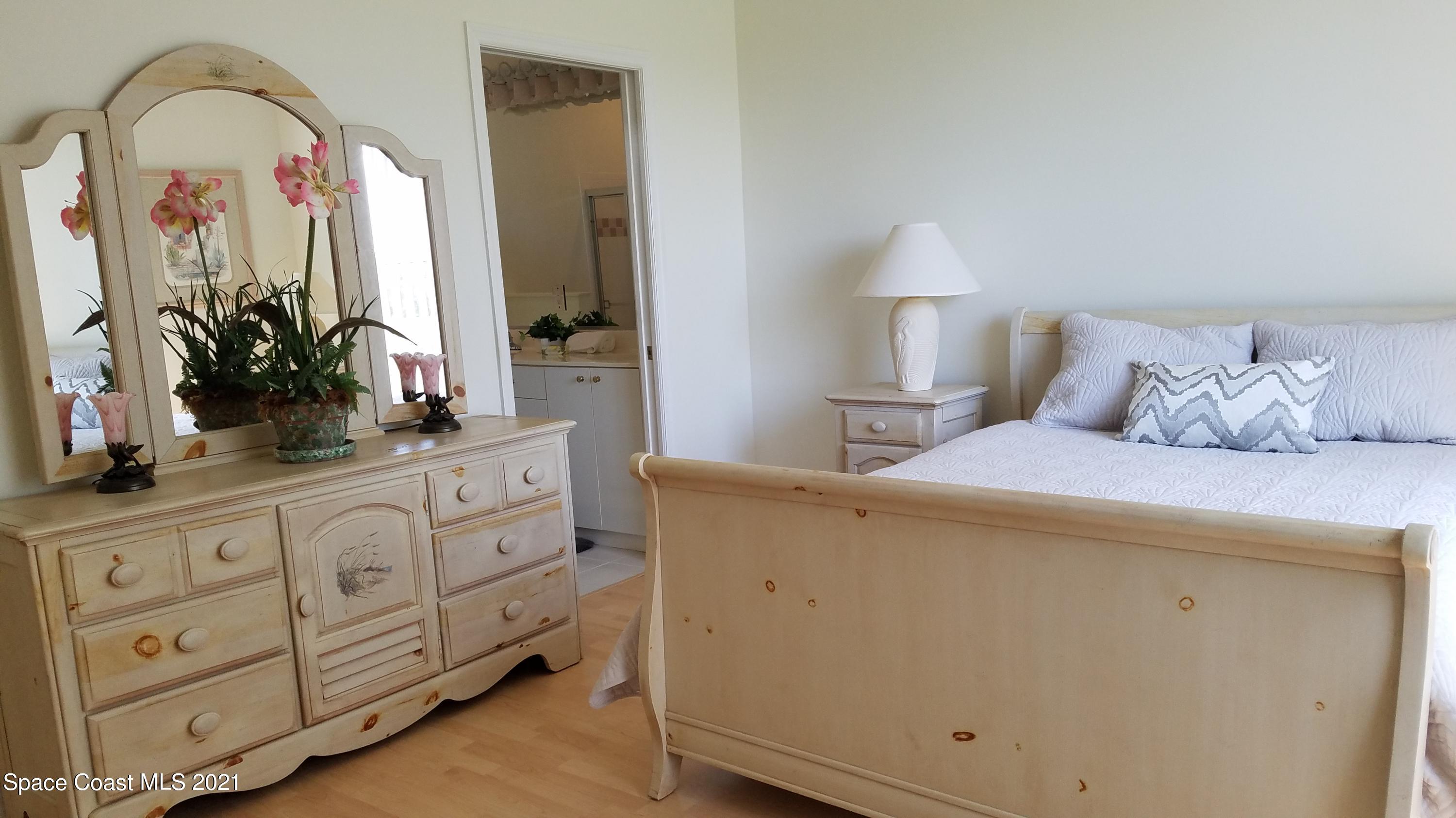 2492 Addington Circle Rockledge, FL 32955 - Photo 15 of 34 a bedroom with a bed and a dresser