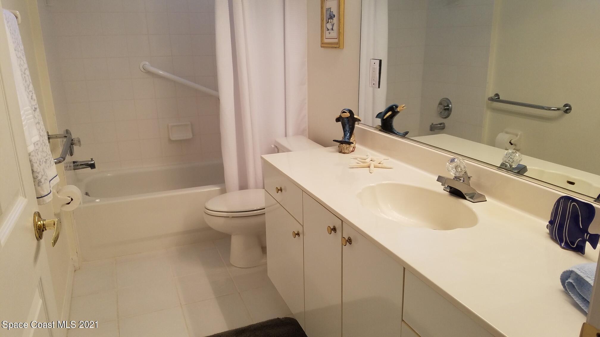 2492 Addington Circle Rockledge, FL 32955 - Photo 19 of 34 a bathroom with a sink a toilet and shower