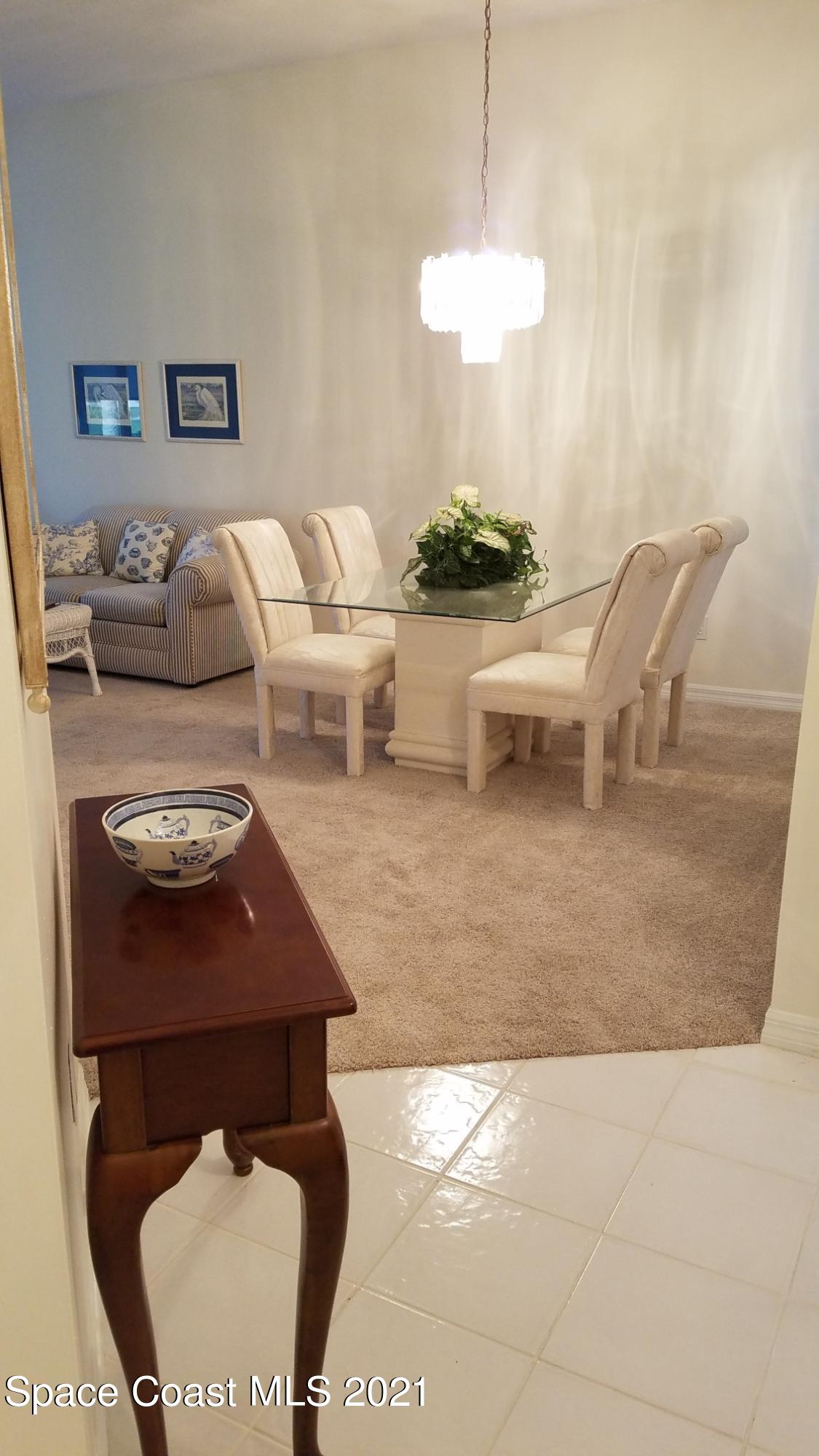 2492 Addington Circle Rockledge, FL 32955 - Photo 7 of 34 a dining room with furniture and a lamp