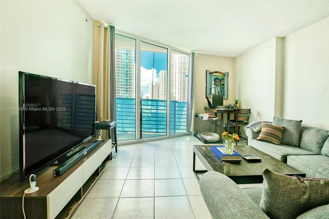 a living room with furniture and a floor to ceiling window