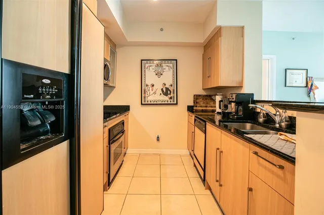 a kitchen with stainless steel appliances granite countertop a sink and cabinets