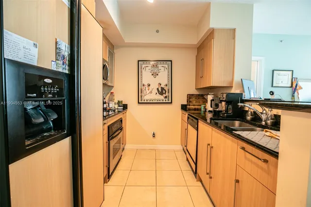 a kitchen with stainless steel appliances a refrigerator and a stove top oven