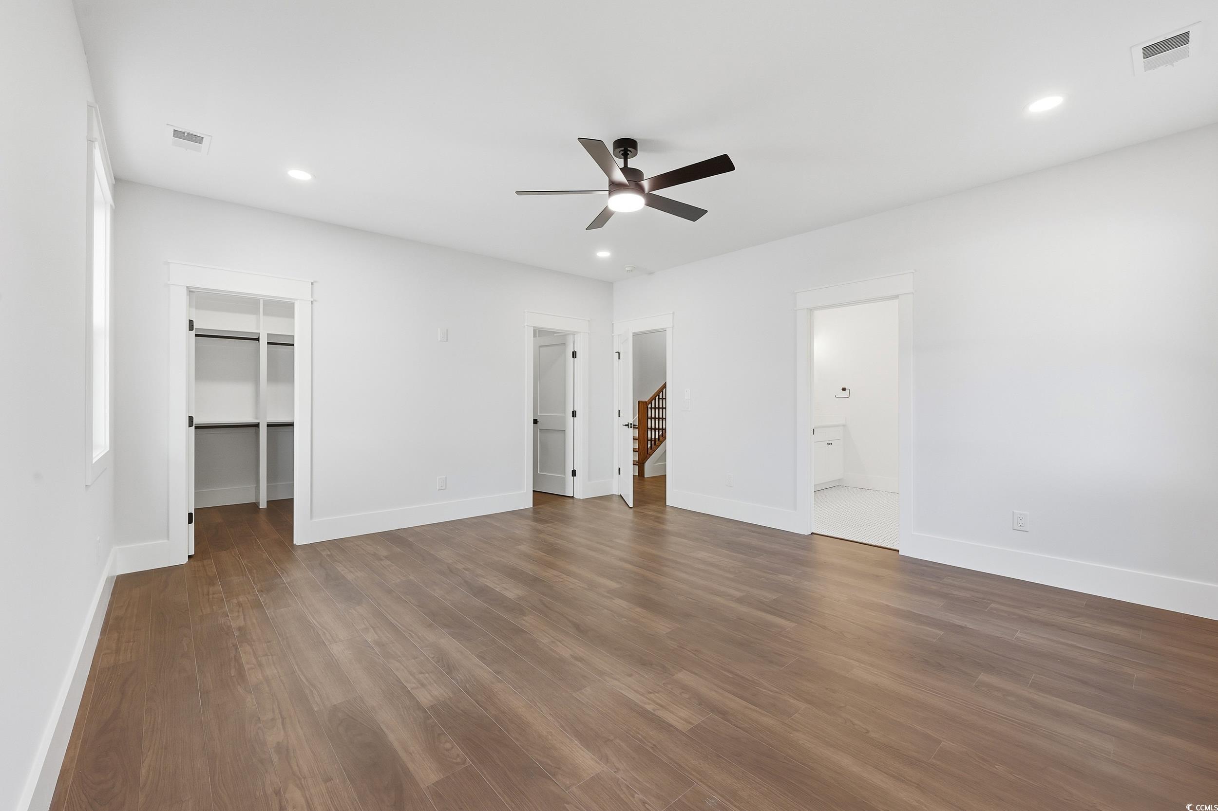 813 Commanders Island Road Georgetown, SC 29440 - Photo 17 of 39 Unfurnished bedroom with a spacious closet, recessed lighting, dark wood-style floors, ceiling fan, and ensuite bathroom