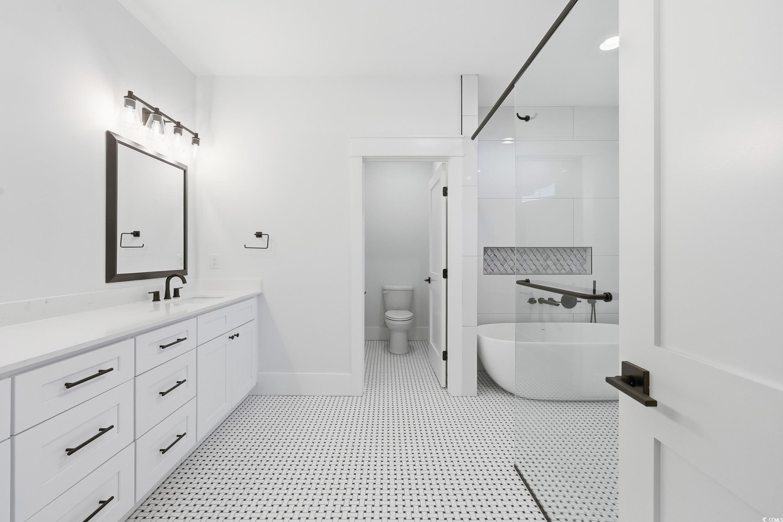 813 Commanders Island Road Georgetown, SC 29440 - Photo 18 of 39 Bathroom featuring a soaking tub, vanity, and a shower