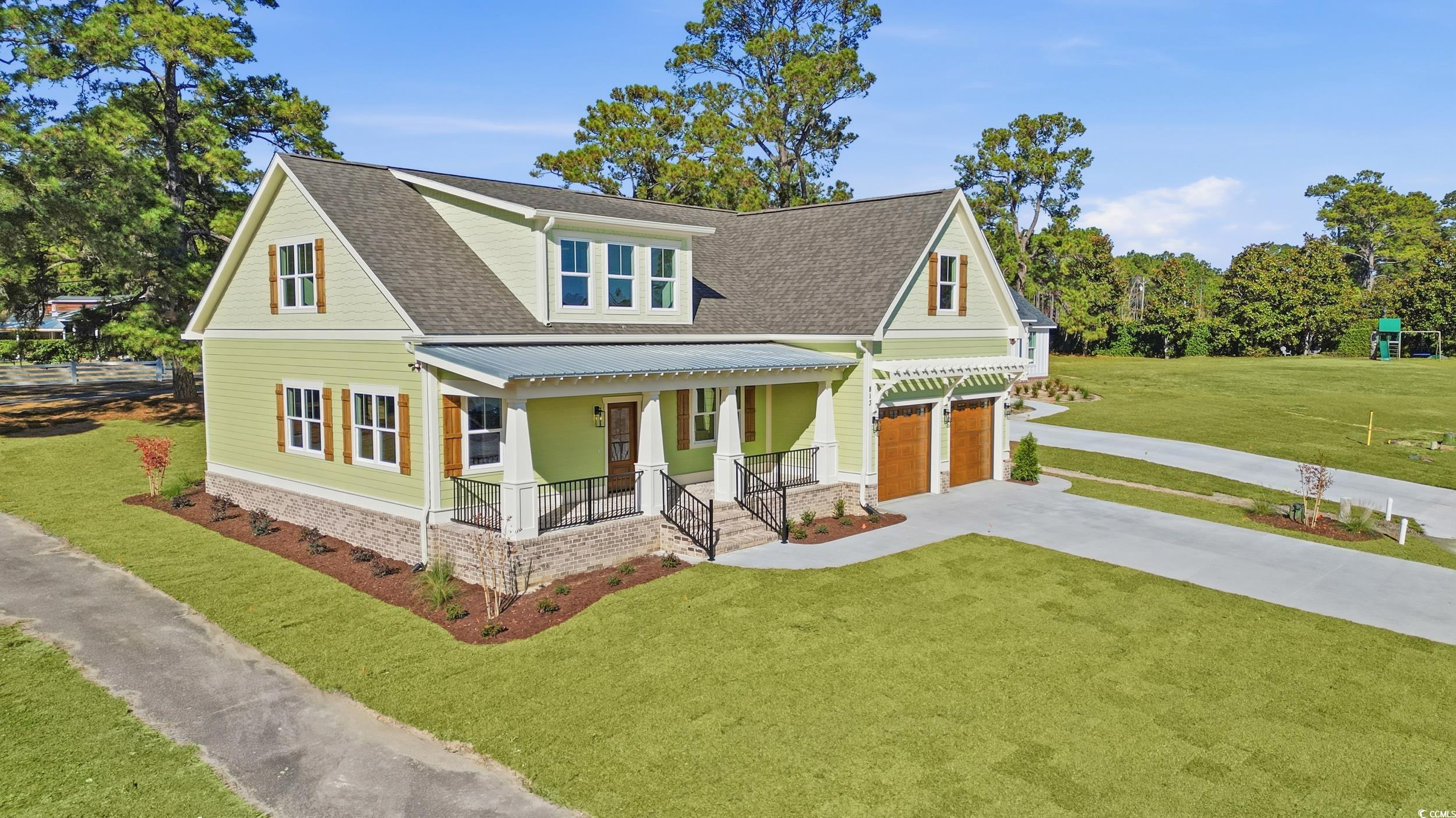 813 Commanders Island Road Georgetown, SC 29440 - Photo 2 of 39 View of front facade with a front yard, a shingled roof, and concrete driveway