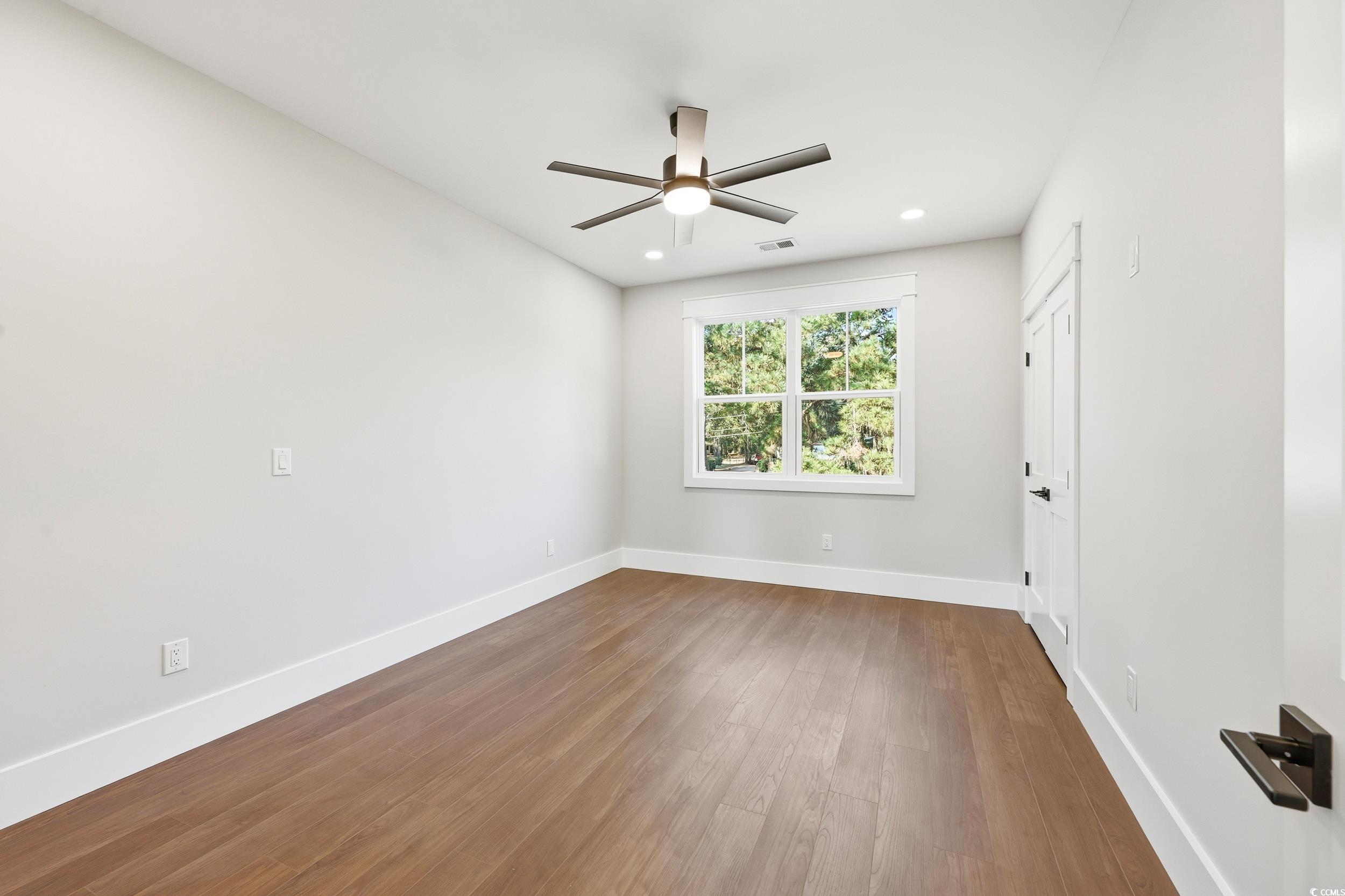 813 Commanders Island Road Georgetown, SC 29440 - Photo 23 of 39 Unfurnished room with wood finished floors, a ceiling fan, and recessed lighting