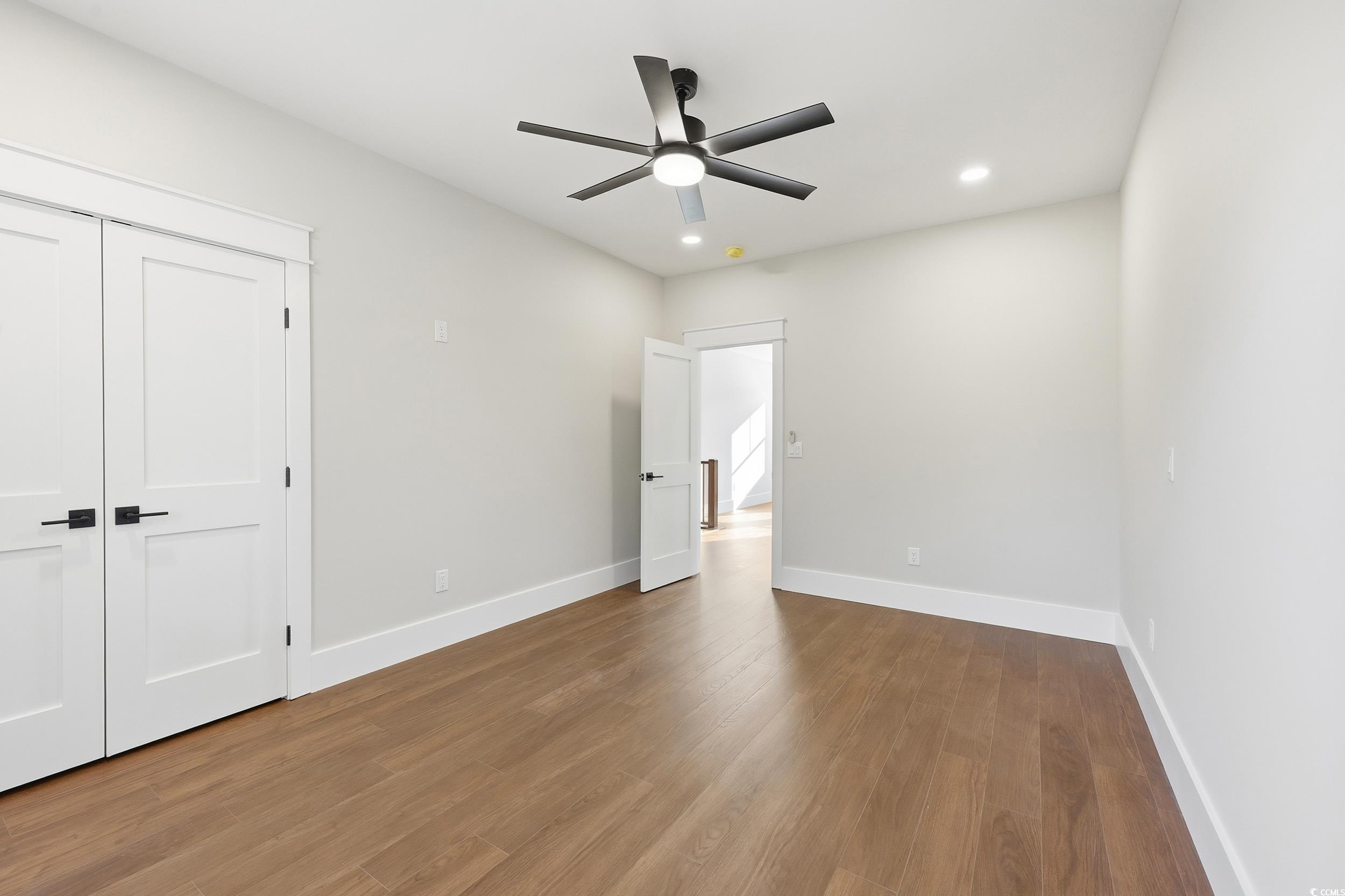 813 Commanders Island Road Georgetown, SC 29440 - Photo 24 of 39 Unfurnished bedroom featuring dark wood-style floors, a ceiling fan, a closet, and recessed lighting