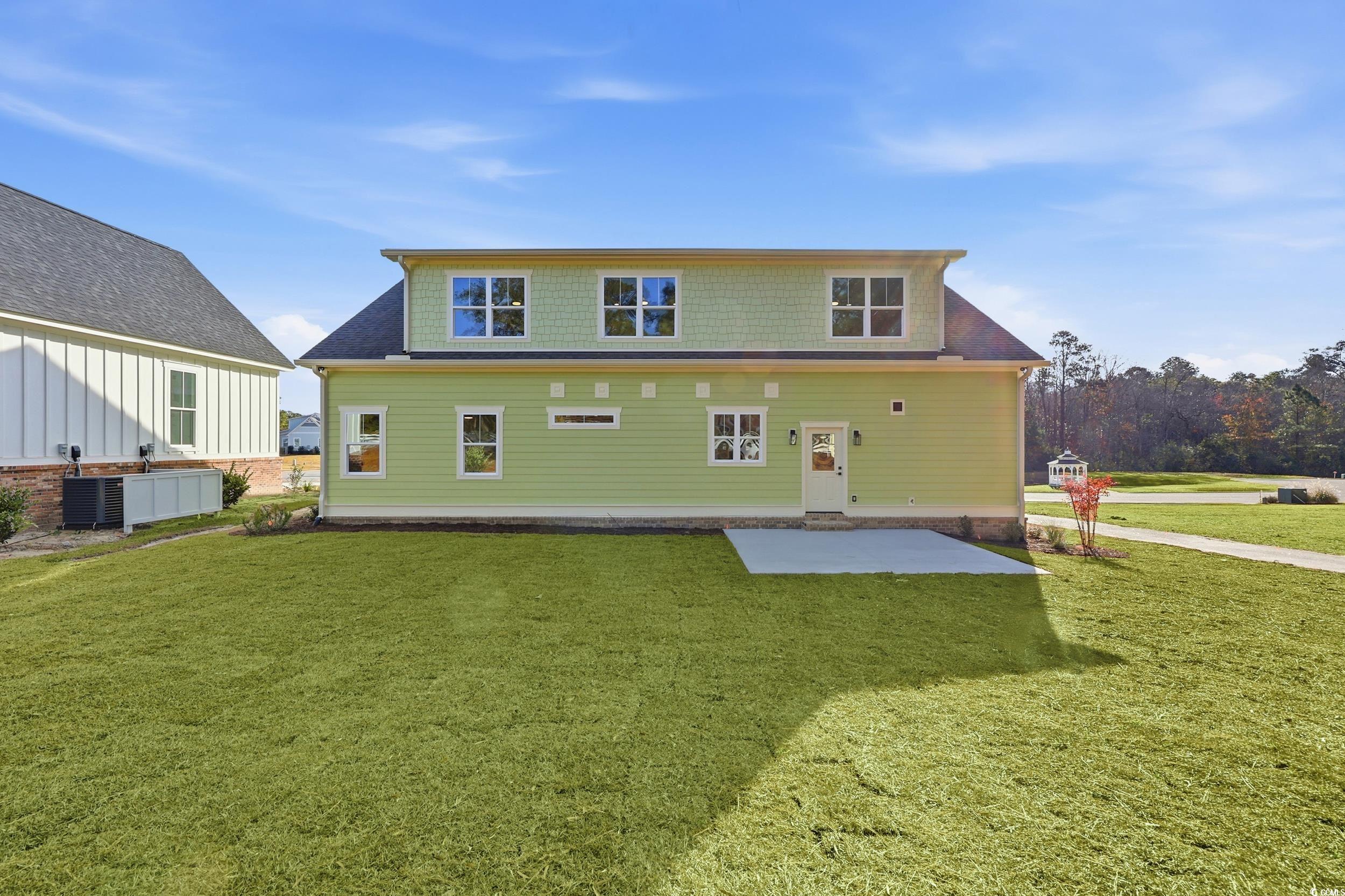 813 Commanders Island Road Georgetown, SC 29440 - Photo 35 of 39 Back of house with a patio area, a lawn, and roof with shingles