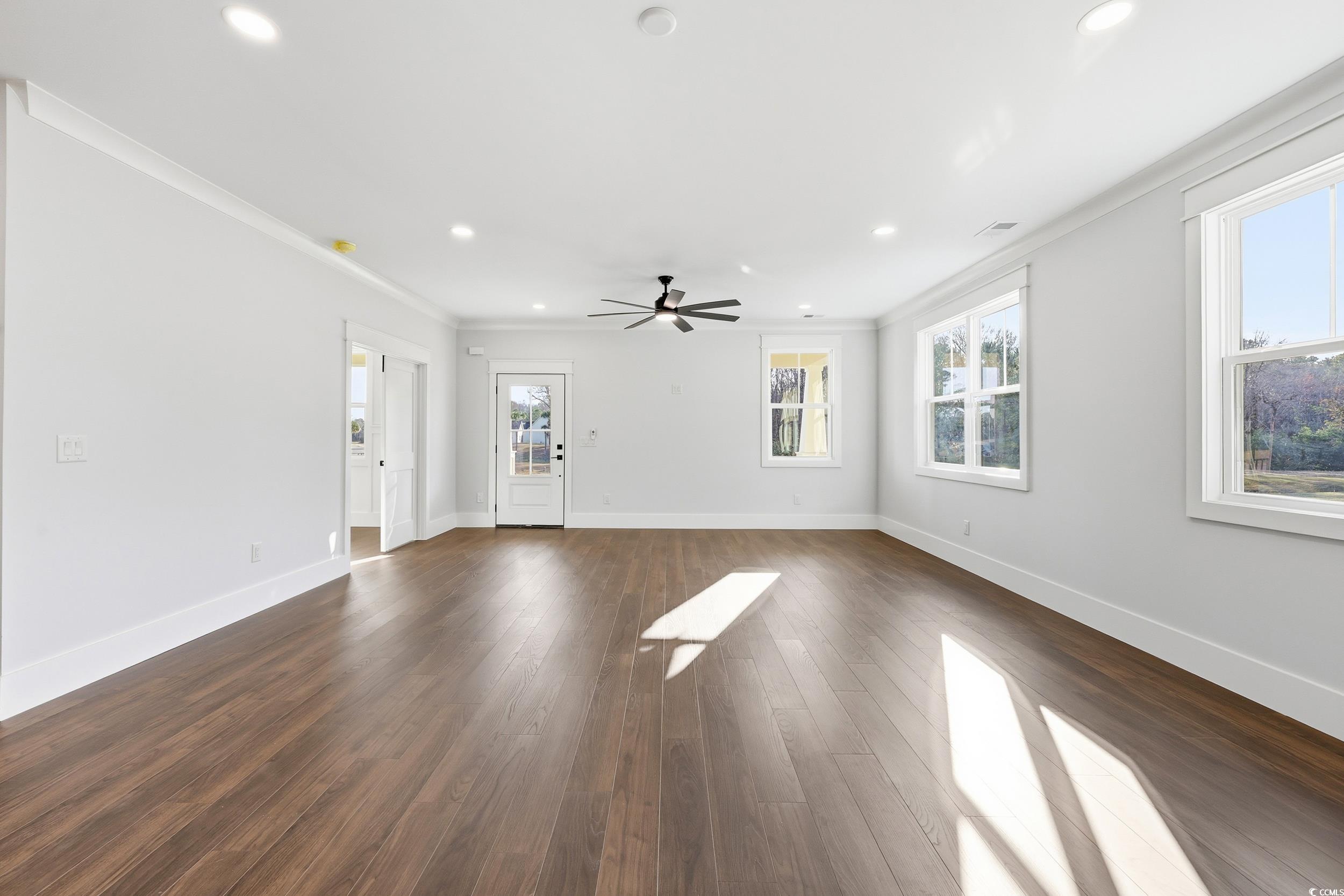 813 Commanders Island Road Georgetown, SC 29440 - Photo 5 of 39 Unfurnished living room featuring dark wood-style flooring, ornamental molding, recessed lighting, and ceiling fan