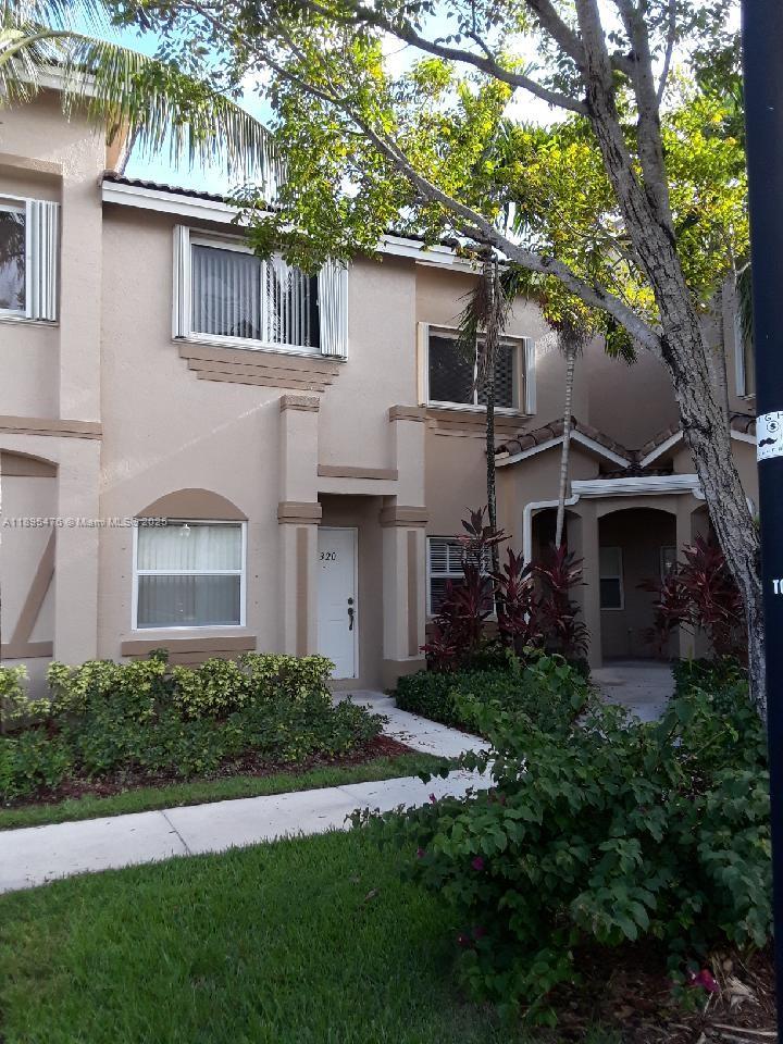 2322 Southeast 23rd Road, Unit 2322 Homestead, FL 33035 - Photo 5 of 11 a front view of a house with a garden