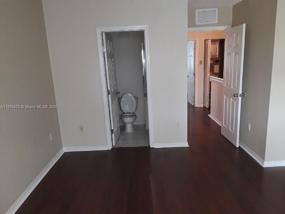 2322 Southeast 23rd Road, Unit 2322 Homestead, FL 33035 - Photo 6 of 11 a view of a hallway with wooden floor