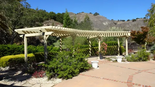 a view of a house with backyard and sitting area