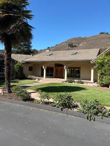a front view of a house with a garden