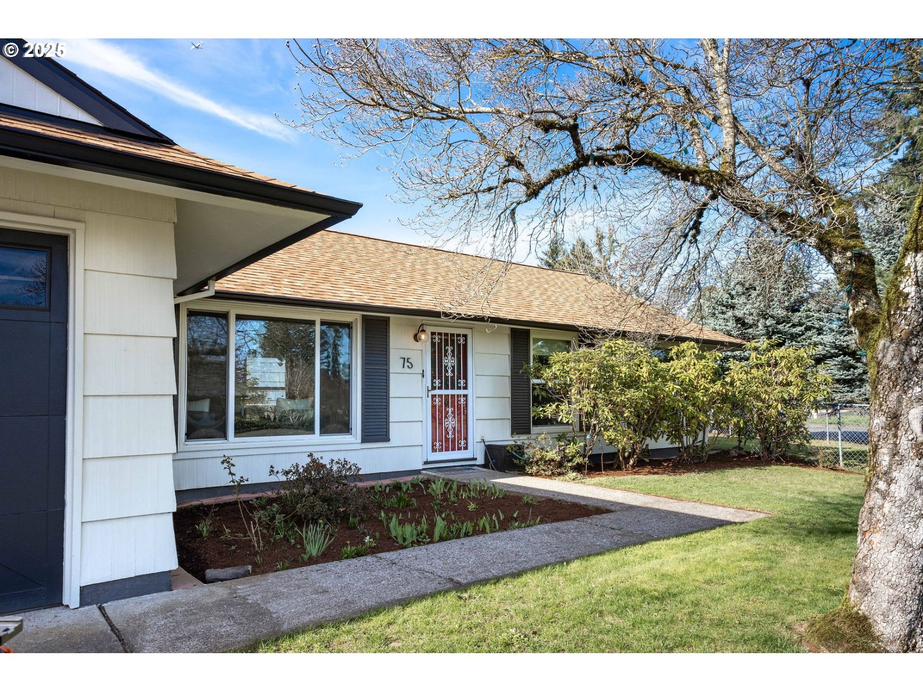 75 Northwest 22nd Street Gresham, OR 97030 - Photo 3 of 32 a front view of a house with a yard