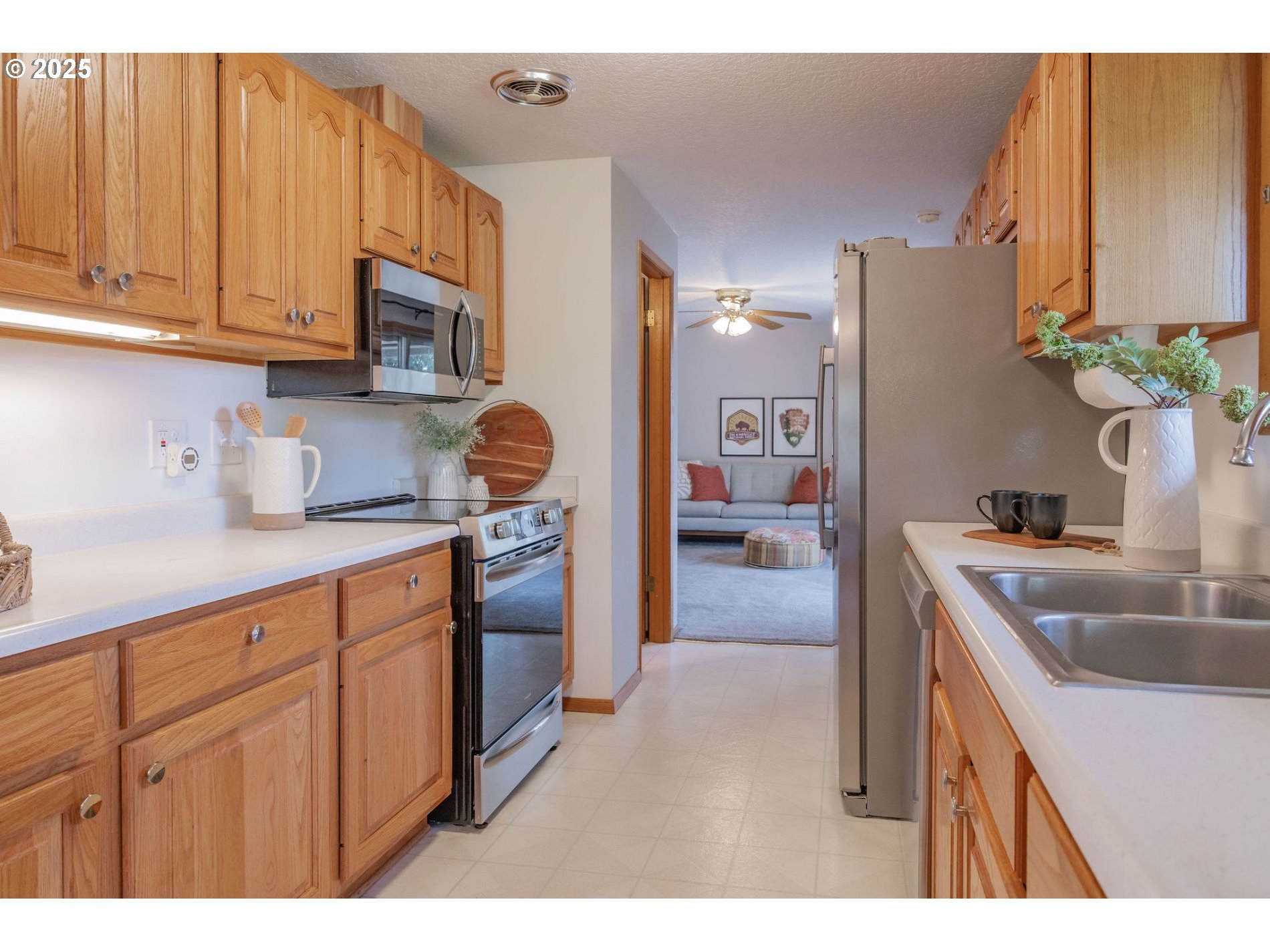 75 Northwest 22nd Street Gresham, OR 97030 - Photo 8 of 32 a kitchen with stainless steel appliances granite countertop a sink dishwasher stove and refrigerator with wooden cabinet