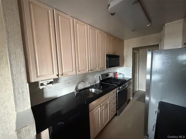 a kitchen with a sink and a refrigerator