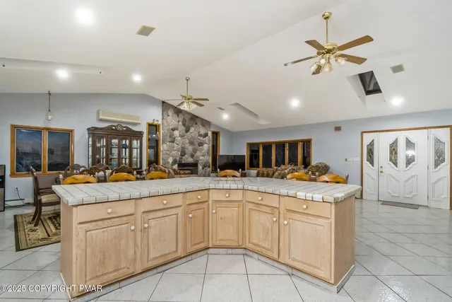 a kitchen with white cabinets and chandelier