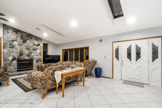 a living room with furniture and a fireplace