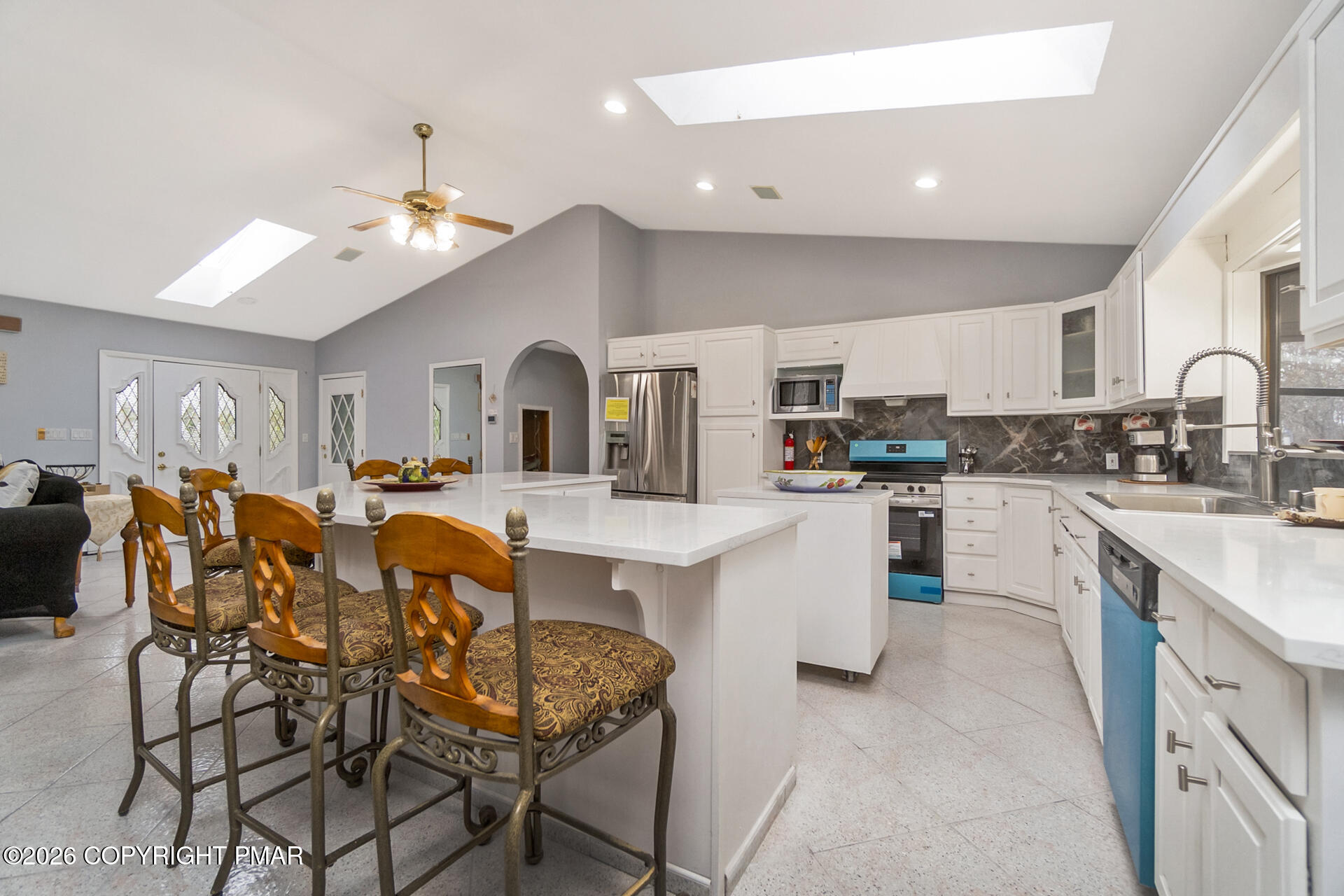 175 Winding Way Albrightsville, PA 18210 - Photo 14 of 54 a kitchen with stainless steel appliances a white table chairs refrigerator and cabinets