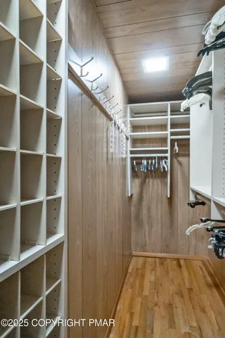a view of walk in closet with empty racks