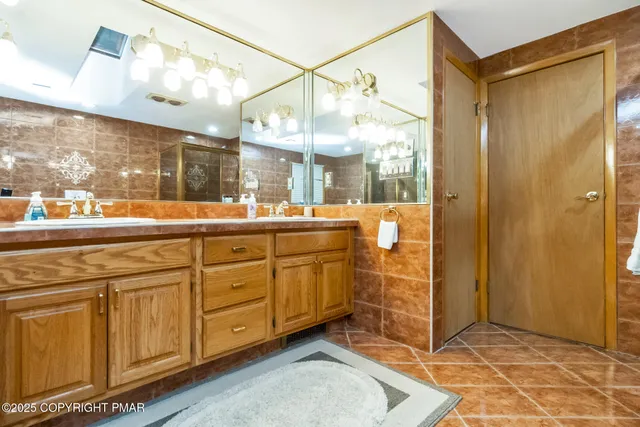 a bathroom with a double vanity sink mirror and
