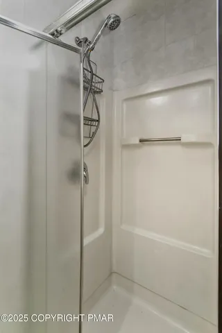 a bathroom with a glass shower door