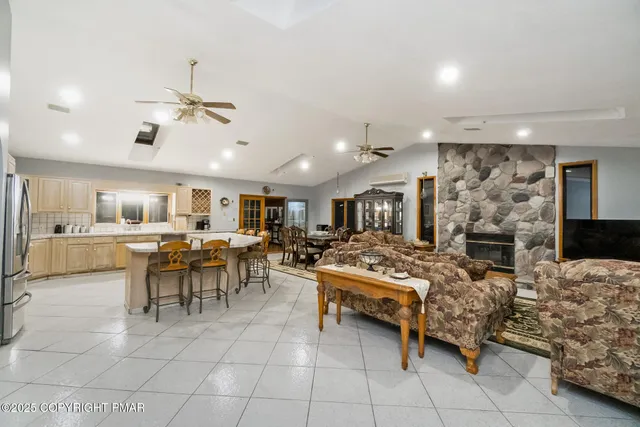 a living room with furniture a dining table and kitchen view