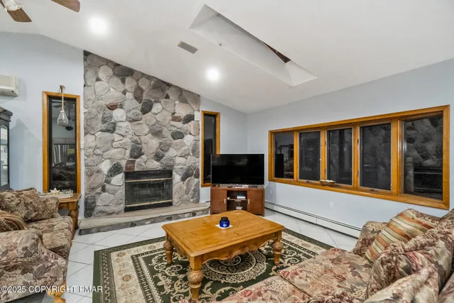 a living room with fireplace furniture and a flat screen tv