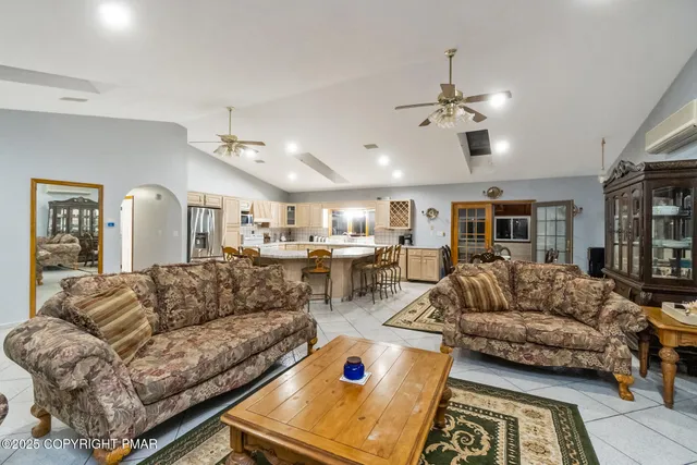 a living room with furniture ceiling fan and a rug