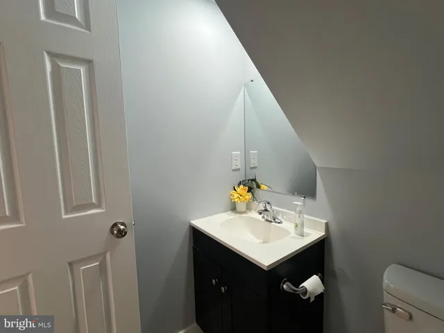 a view of an empty room and chandelier fan