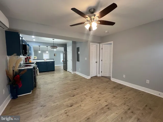 a kitchen with stainless steel appliances granite countertop a stove and a wooden floors