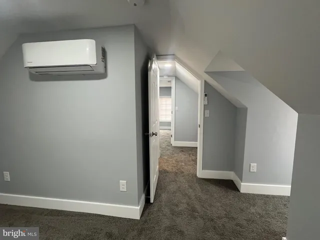 a view of a house with backyard and trees