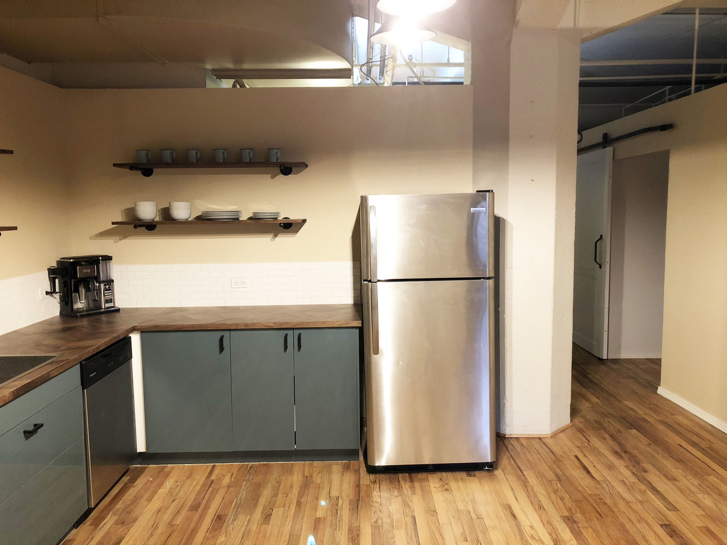124 West Polk Street, Unit 101 Chicago, IL 60605 - Photo 4 of 14 a kitchen with a refrigerator and wooden floor
