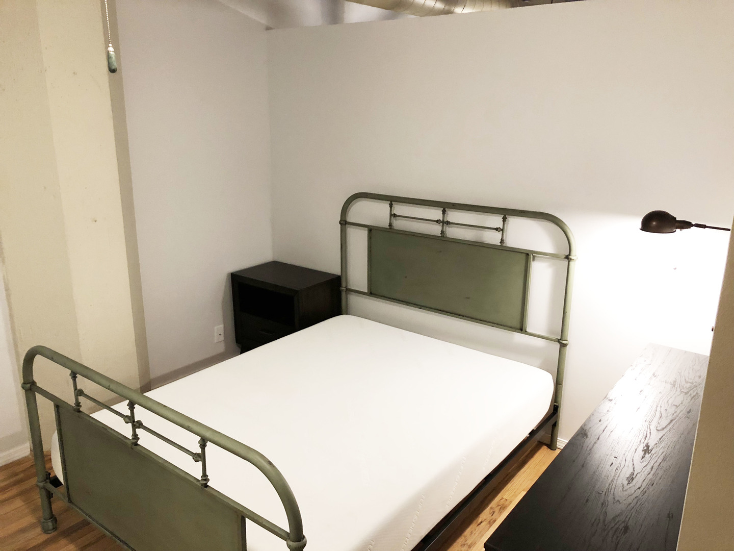 124 West Polk Street, Unit 101 Chicago, IL 60605 - Photo 9 of 14 a bedroom with a bed and wooden floor