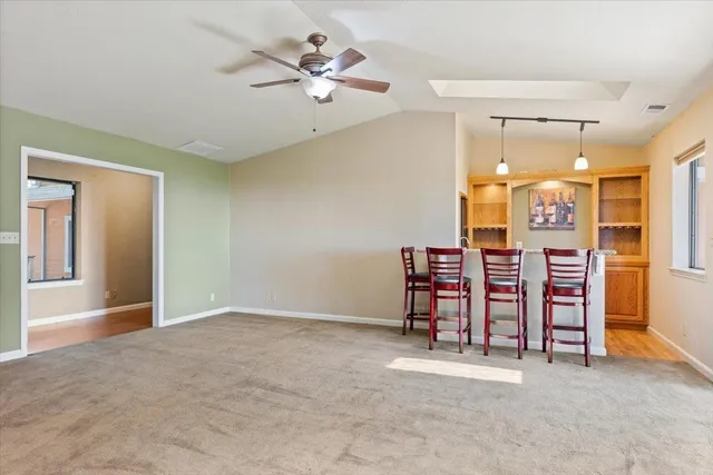 a view of an empty room with a fireplace and a window