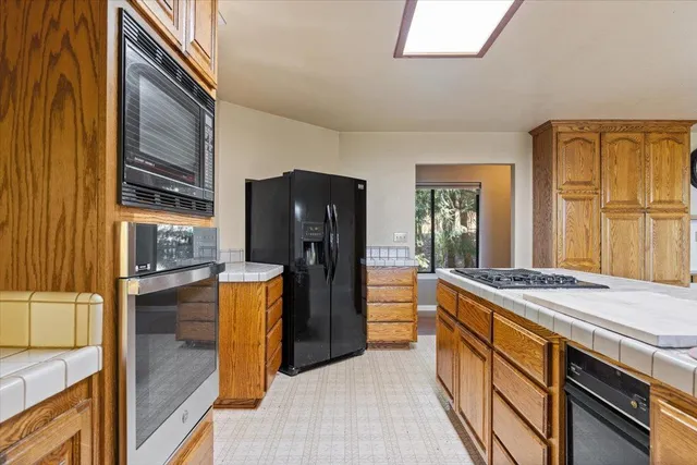 a view of an empty room with a fireplace and a window