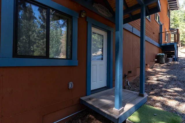 a kitchen with stainless steel appliances granite countertop a stove top oven a sink dishwasher a dining table and chairs with wooden floor