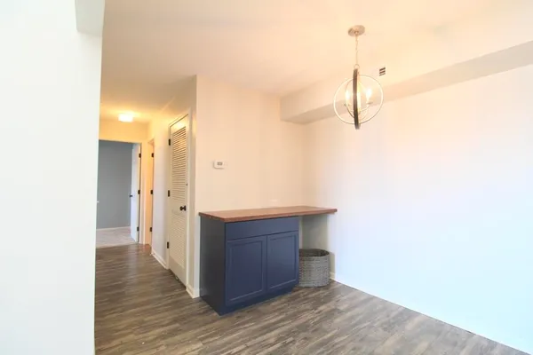 a view of a room with wooden floor