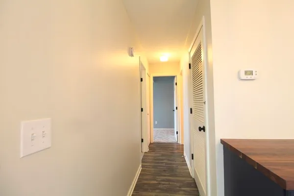 a view of a hallway with wooden floor
