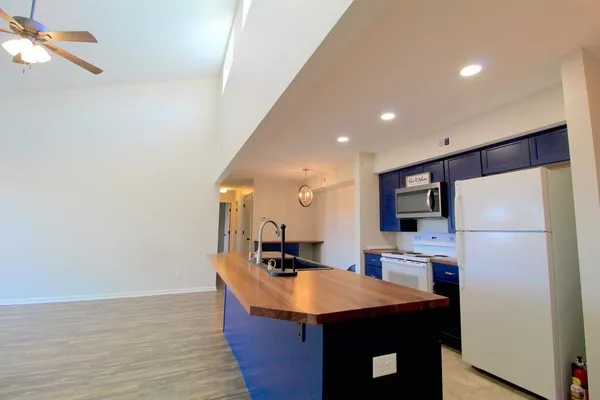 a kitchen with stainless steel appliances a refrigerator and a dining table