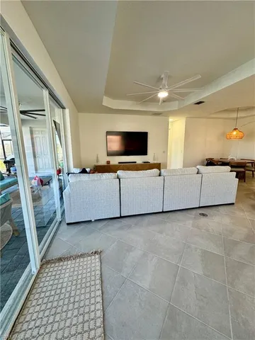 a spacious bedroom with a bed and ceiling fan