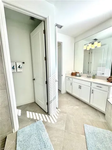 a front view of a house with a yard and potted plants