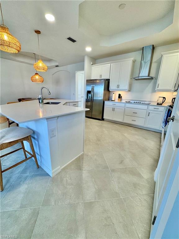 5376 Fancourt Links Way Ave Maria, FL 34142 - Photo 8 of 39 Kitchen with a raised ceiling, recessed lighting, white cabinets, stainless steel fridge with ice dispenser, and pendant lighting