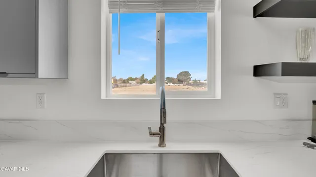 a kitchen with a sink and a window