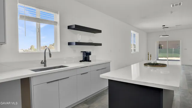 a kitchen with a sink and a refrigerator