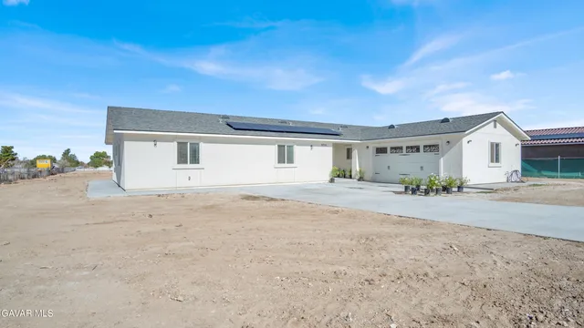 a view of a house with a backyard and a garage