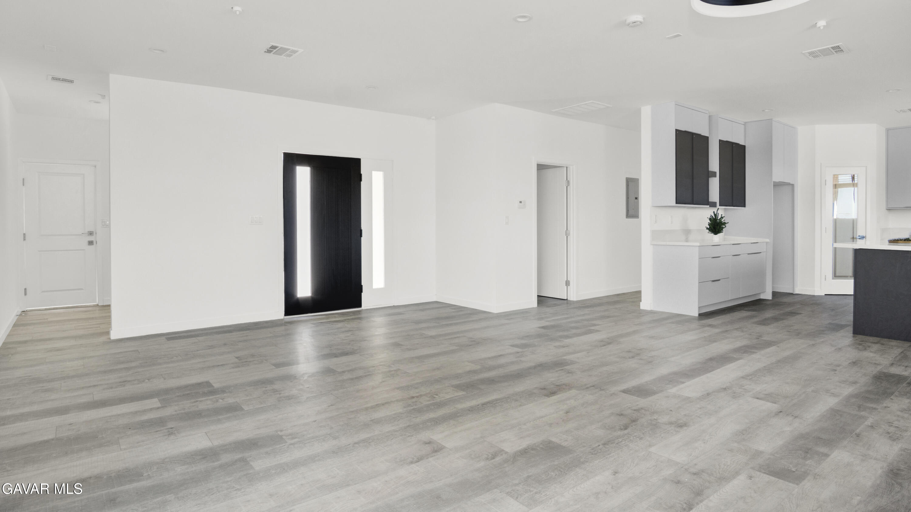 9701 E Avenue South Littlerock, CA 93543 - Photo 5 of 35 a view of a kitchen with flat screen tv and refrigerator