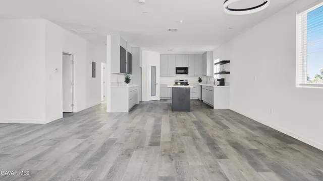 a kitchen with kitchen island a sink stove and refrigerator
